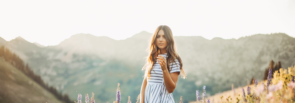 Woman wearing striped dress in field